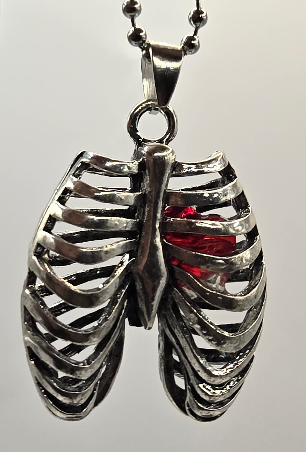 MR. BONES' RIB CAGE/CRYSTAL HEART PENDANT