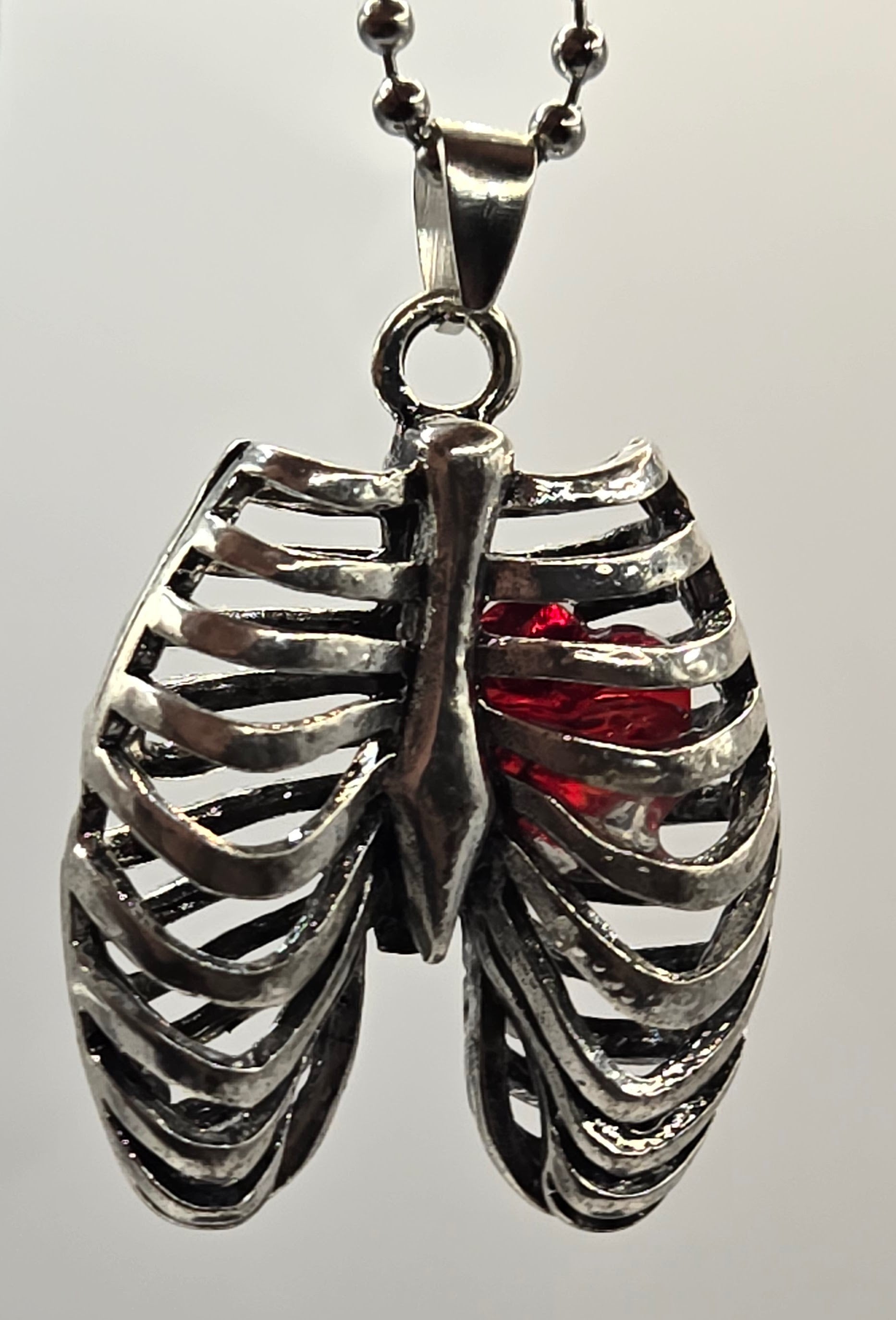 MR. BONES' RIB CAGE/CRYSTAL HEART PENDANT